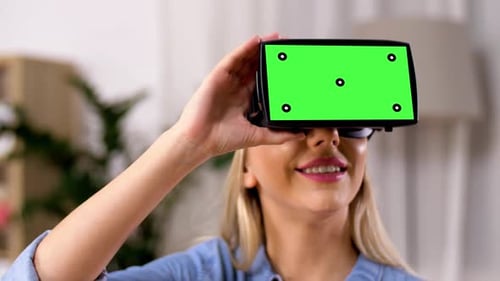 Smiling Woman Using Virtual Reality Headset in Home