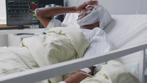 Injured Black Man with Brain Concussion on Hospital Bed