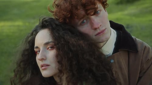 Portrait of Young Loving Couple Hugging Each Other on Green Lawn