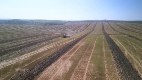 Tractor working on the field doing tillage with cultivator