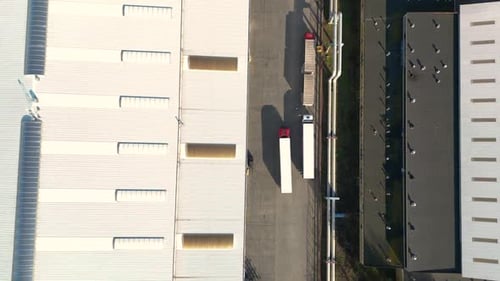 Top Down Drone View of Semi Trucks at Logistics Warehouse