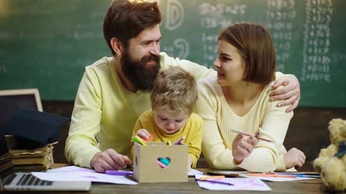 Family Together at Desk Drawing with Markers