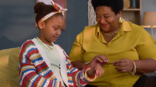 Woman and Girl Try on Jewelry Together at Home