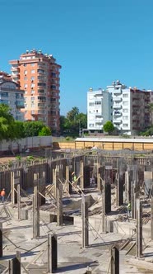 Construction Workers Building Urban Foundation on Sunny Day
