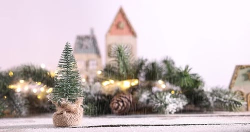 Miniature Christmas village decoration with snow falling gently