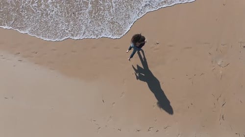 A Romantic Couple Running Towards Each Other To Embrace At Praia do Lago Beach In A Coruna, Spain. A