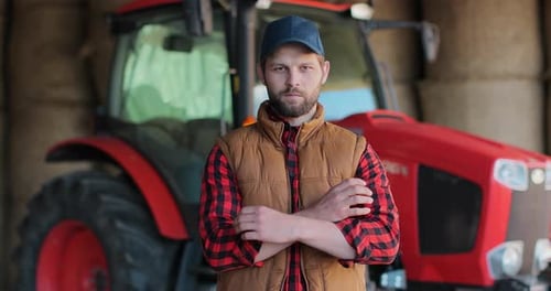 Farmer Poses in Front of Modern Red Tractor