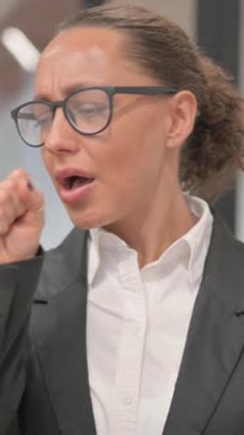 Portrait of Coughing Sick Hispanic Business Woman, vertical video