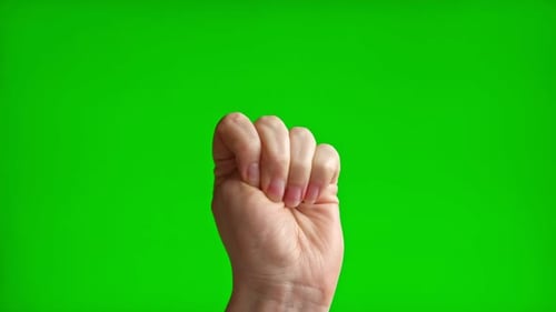 Female Hand with Beige Manicure Making Rise Up Sign Symbol with Her Fist Chroma Key Green Screen