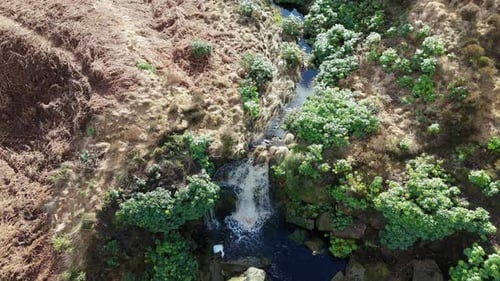 Aerial drone footage of a tall rocky waterfall in the Yorkshire Dales, Pennies. Moorland scene of a