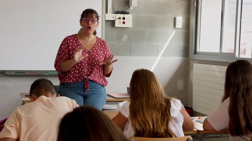 Enthusiastic Teacher Giving Lesson to High School Students