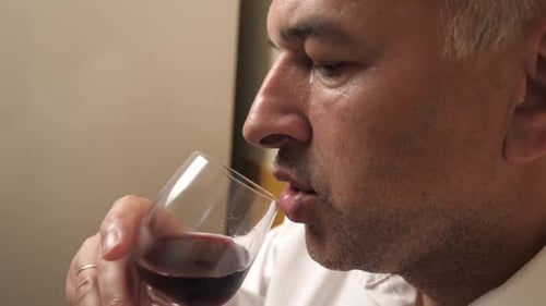 Man Enjoys a Glass of Red Wine