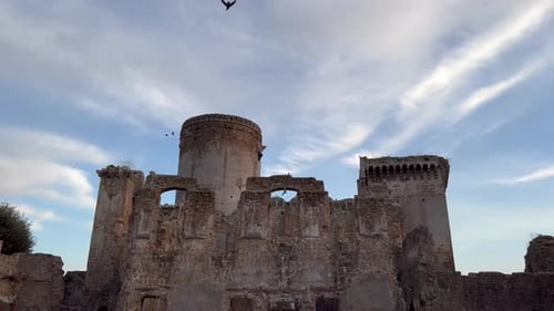 Abandoned Borgia Castle ruin, Italy. Crows flying. Evening. Title Space