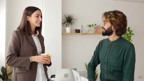 Two Smart Business Coworkers Taking Break in the Office