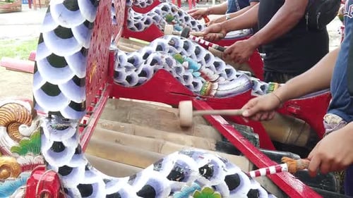 Closeup Hands of Gamelan Bamboo Percussion Musicians Playing Jegog Balinese Ensemble with Interlocki
