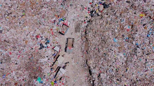 Aerial view from top of garbage dump with many dustman