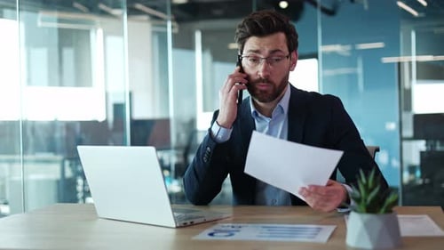 Focused Man Talking on Phone in Modern Office