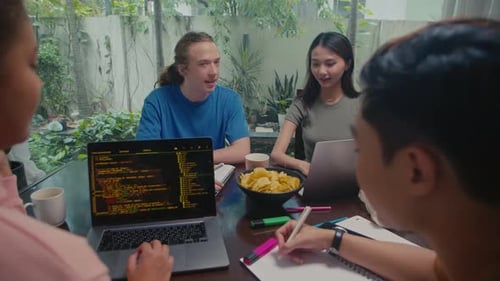 Young IT Specialists Developing Software Using Computers at Home