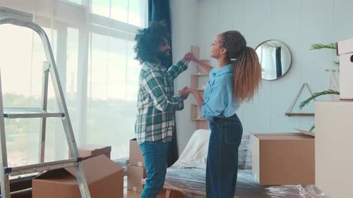 Joyful Couple Dancing in New Home