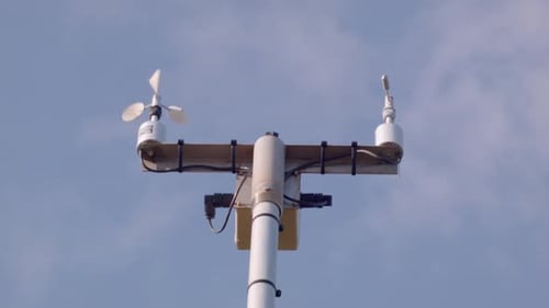 A low angle close up of the equipment used to measure wind speed and direction.