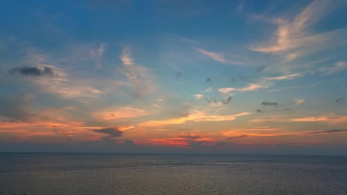 Drone aerial view of endless horizon over the sea in golden sunset. 4K.