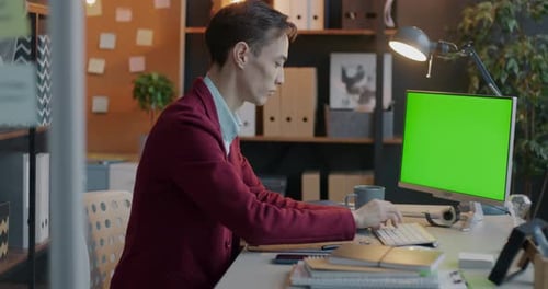 Biracial Young Businessman Using Chroma Key Green Screen Computer Typing Looking at Monitor in