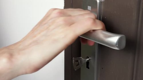 Hand Locking Up The Door With Key