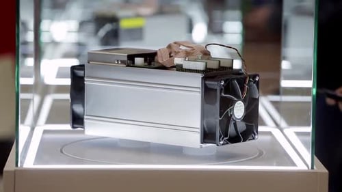 Cryptocurrency Mining Equipment ASIC Application Specific Integrated Circuit on Farm Stand at Expo