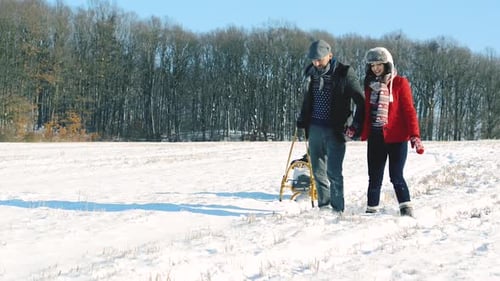 Father and Mother Pulling Daughter on Sledge, Running