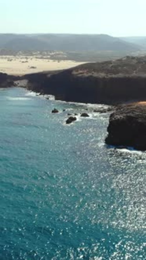 Vast Cliffs Meet Blue Sea Sweeping Aerial Shot of Dramatic Coastal Landscape with Calming Waves