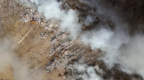 Aerial view of landfill with burning trash piles