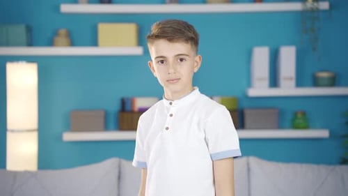 Boy Smiles and Waves Hello Indoors