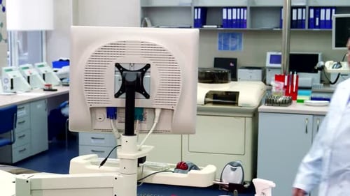 Man Working With Computer in Medical Lab