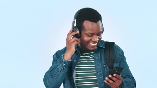 Dance, headphones and black man in studio with phone for streaming song, radio and audio