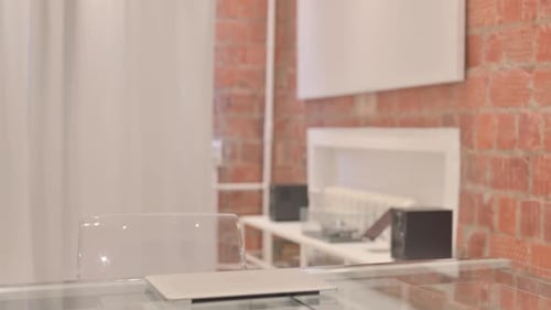 Young Woman Coming to Office and Starting Work on Laptop