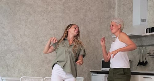 Two Women Dancing Together in the Kitchen