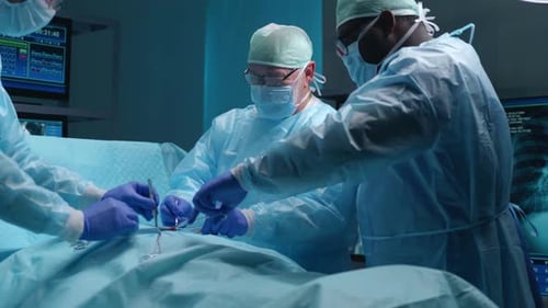 Team of Professional Medical Surgeons Performs the Surgical Operation in a Modern Hospital Doctors