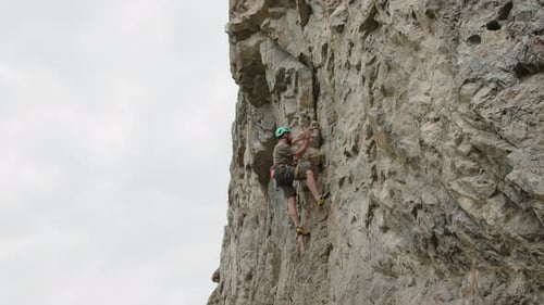 Climber Going Up Steep Rock