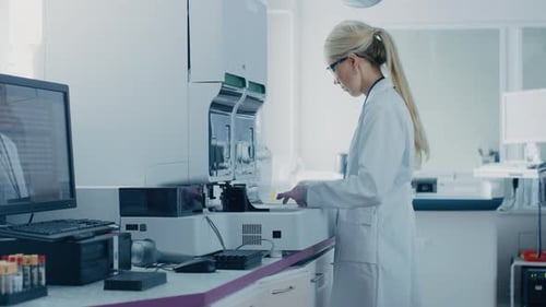 Blonde woman working with laboratory equipment in lab