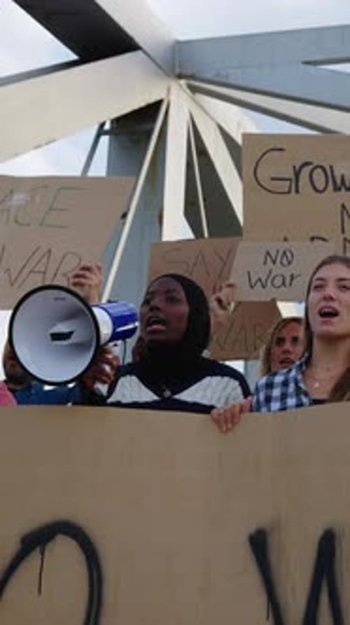 Young Adults Protest With Signs and Megaphone