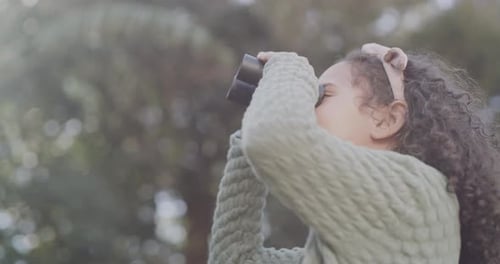 Curious, fun and playful child with binoculars looking outside, watching birds