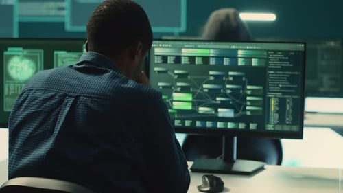 Man Working at Computer in Tech Workplace