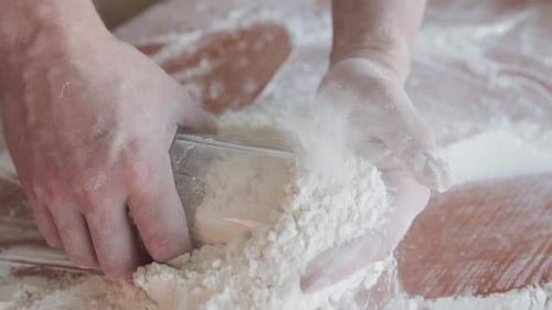 Hands Adding Flour to Make Homemade Dough