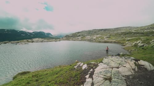 guy travels on a beautiful mountain road in norway