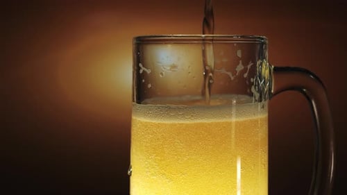 Beer Being Poured into Glass Mug with Bubbles