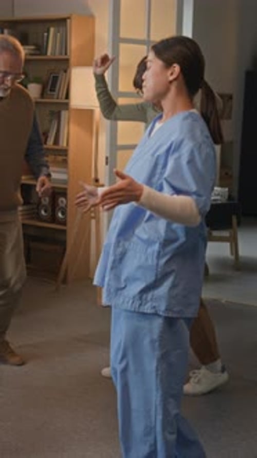 Senior Couple Dancing with Caregiver in Living Room