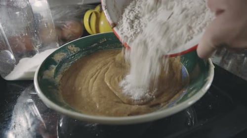 Adding Flour To Cookie Dough Mixture In The Kitchen - close up