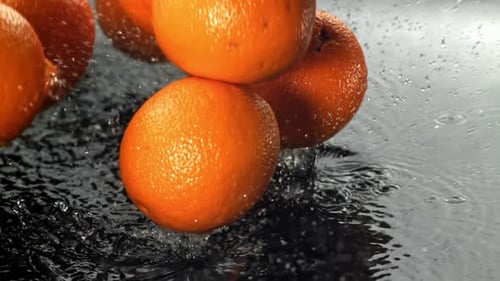 Oranges Fall on a Wet Surface Filmed on a Highspeed Camera at 1000 Fps