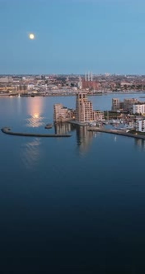 Aerial drone view of Osterbo Nord, Nordhavn harbour area at the coast of the Oresund at sunset. Vert