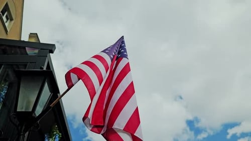 United States flag waving against a cloudy sky